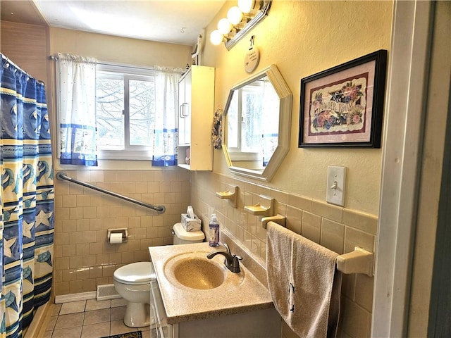bathroom with vanity, tile walls, toilet, and tile patterned floors