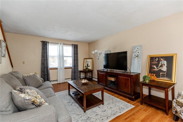 23 Oak Grove Blvd, North Providence, RI 02911 - living area with light wood-style floors and a baseboard radiator