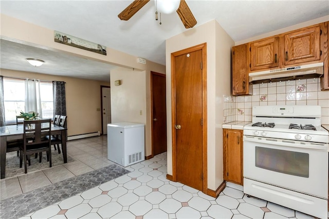 23 Oak Grove Blvd, North Providence, RI 02911 - kitchen with white gas range, ceiling fan, fridge, a baseboard radiator, and under cabinet range hood