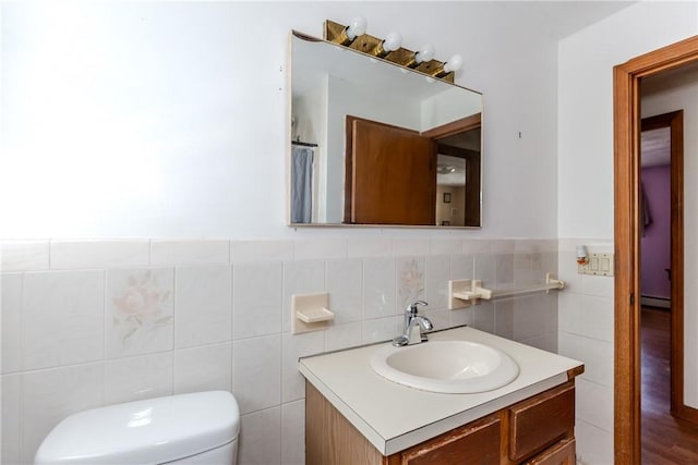 23 Oak Grove Blvd, North Providence, RI 02911 - bathroom featuring vanity, a baseboard heating unit, toilet, and tile walls