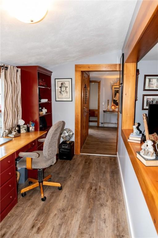 office space with wood finished floors and vaulted ceiling