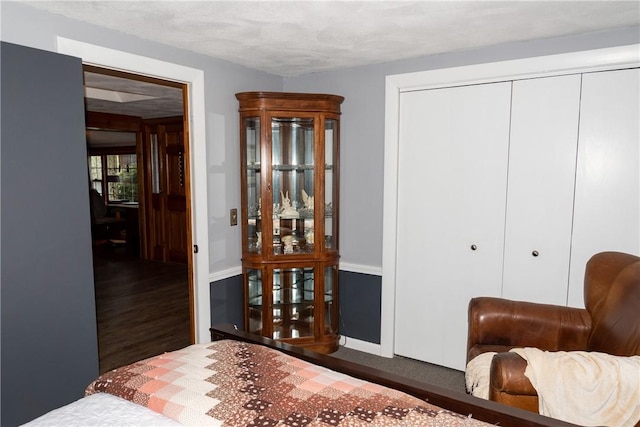 bedroom with baseboards, a closet, and wood finished floors