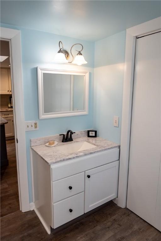 bathroom with wood finished floors and vanity