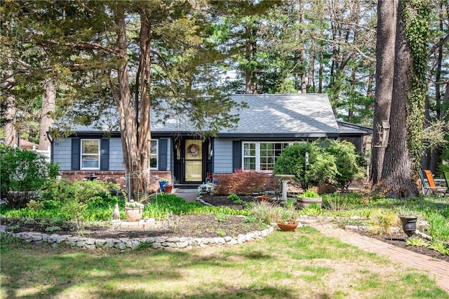 ranch-style house featuring brick siding