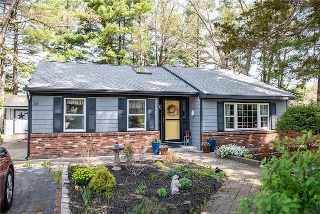 single story home with brick siding and a shingled roof