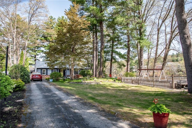 exterior space with aphalt driveway and fence
