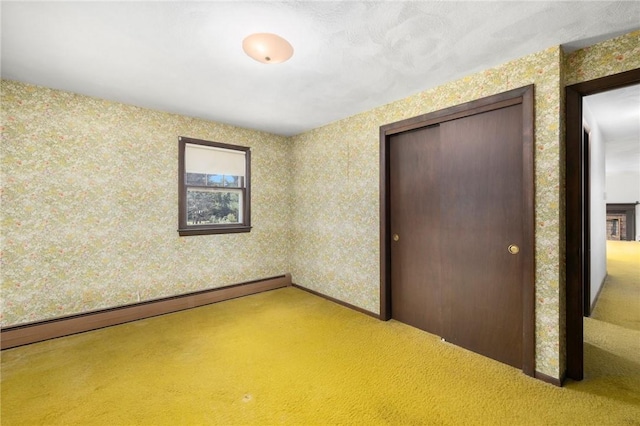 49 Magnolia Ln, Coventry, RI 02816 - unfurnished bedroom with carpet flooring, a baseboard radiator, and wallpapered walls
