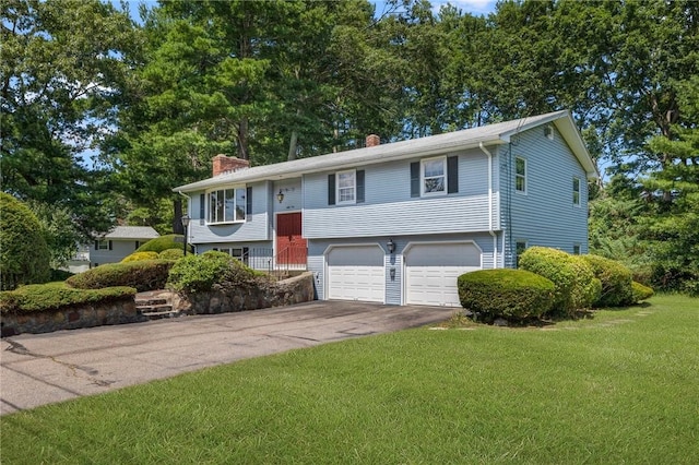 49 Magnolia Ln, Coventry, RI 02816 - split foyer home with a garage, a front lawn, driveway, and a chimney