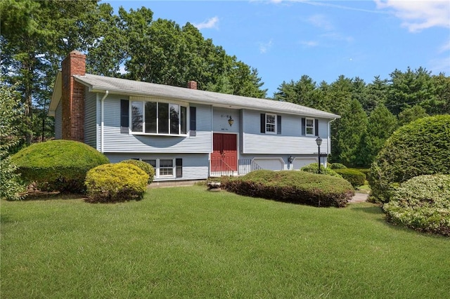 49 Magnolia Ln, Coventry, RI 02816 - bi-level home featuring a chimney, a front lawn, and a garage