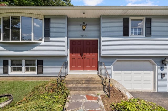 49 Magnolia Ln, Coventry, RI 02816 - entrance to property featuring an attached garage and driveway