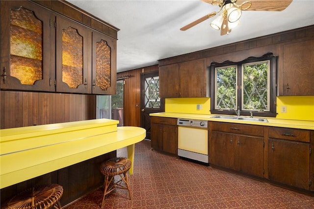 49 Magnolia Ln, Coventry, RI 02816 - kitchen with a ceiling fan, white dishwasher, light countertops, a sink, and wooden walls