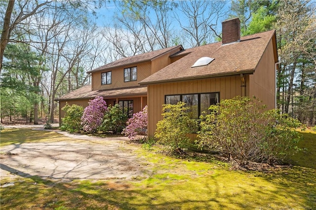 view of front of property featuring roof with shingles and a chimney