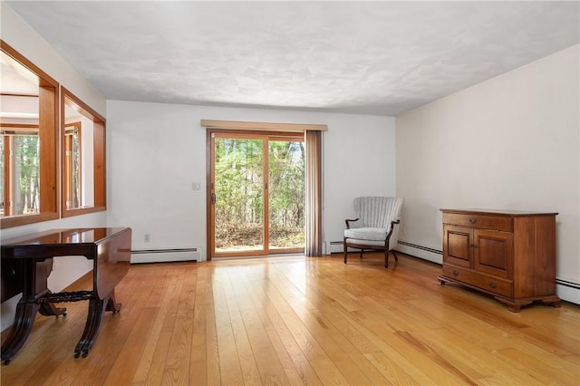 living area featuring a baseboard radiator and light wood-style flooring