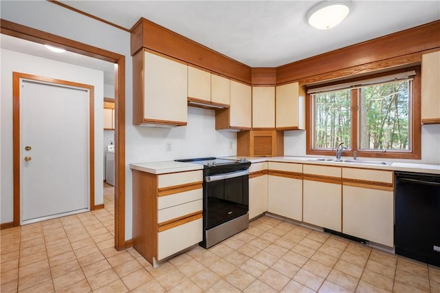 kitchen with washer / clothes dryer, light countertops, a sink, stainless steel electric stove, and black dishwasher