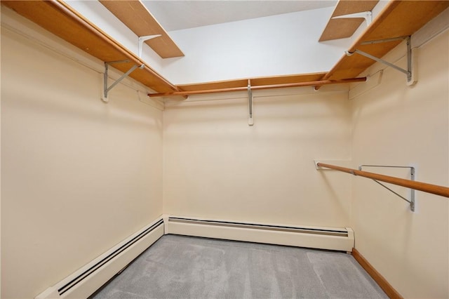 spacious closet featuring carpet flooring and a baseboard heating unit