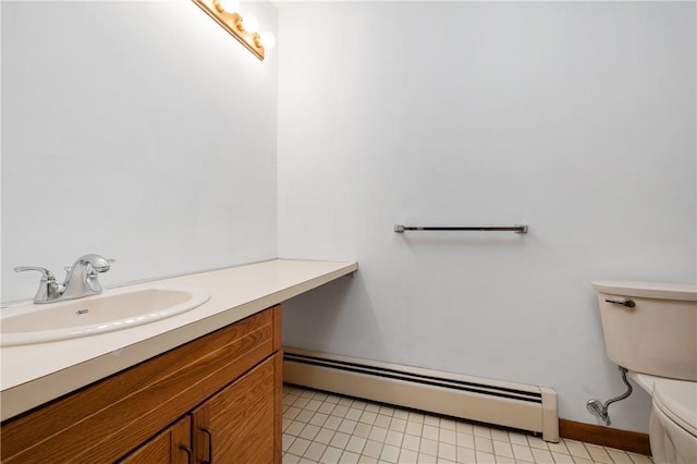 bathroom with toilet, a baseboard heating unit, and vanity