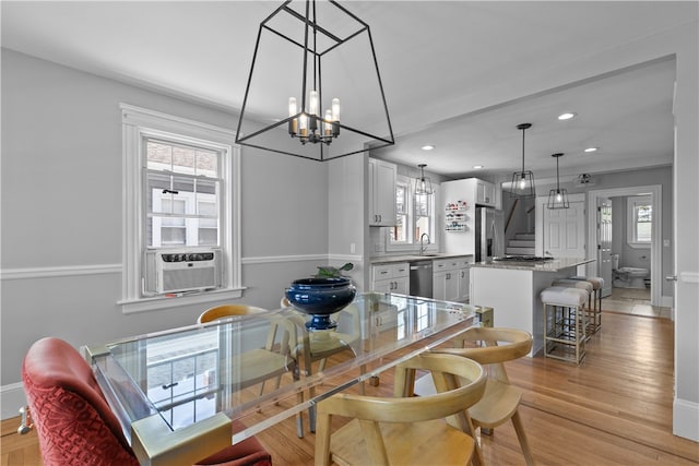 dining room with recessed lighting, light wood-style flooring, a notable chandelier, and stairway