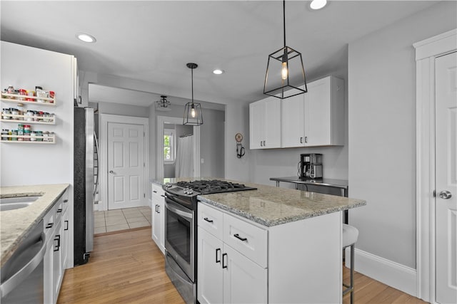 kitchen featuring a center island, recessed lighting, white cabinetry, and stainless steel appliances