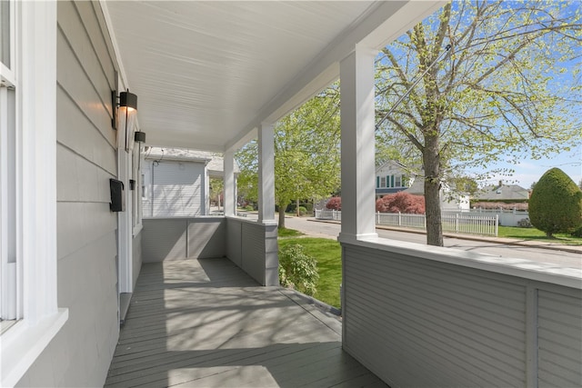 wooden terrace with fence and covered porch