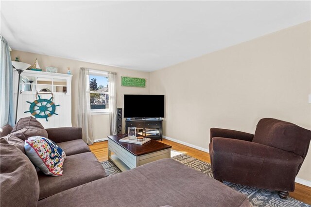 living area with baseboards and light wood-style flooring