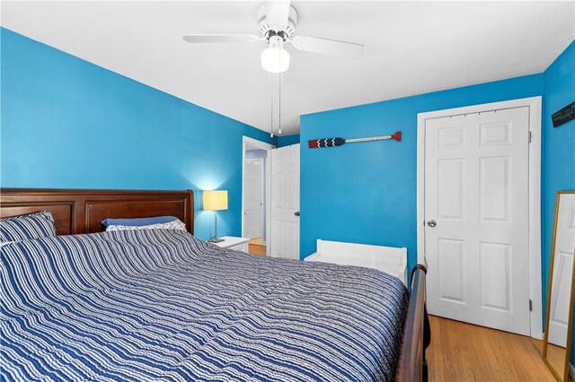 bedroom featuring a ceiling fan and wood finished floors