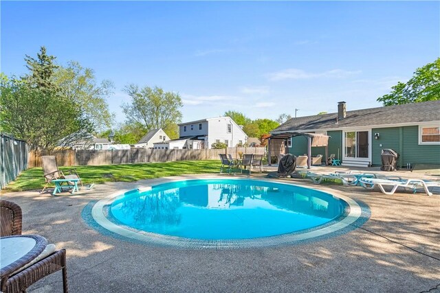view of pool with a fenced in pool, a fenced backyard, and a patio area