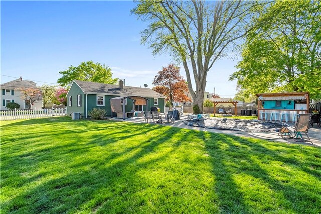view of yard featuring a patio, a fenced backyard, central air condition unit, and an outdoor structure