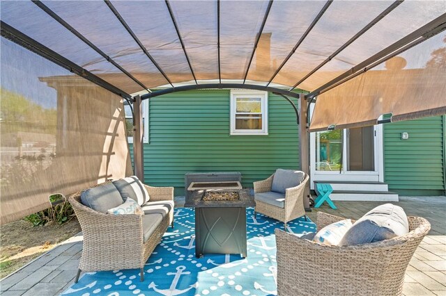 view of patio with an outdoor living space with a fire pit and a pergola