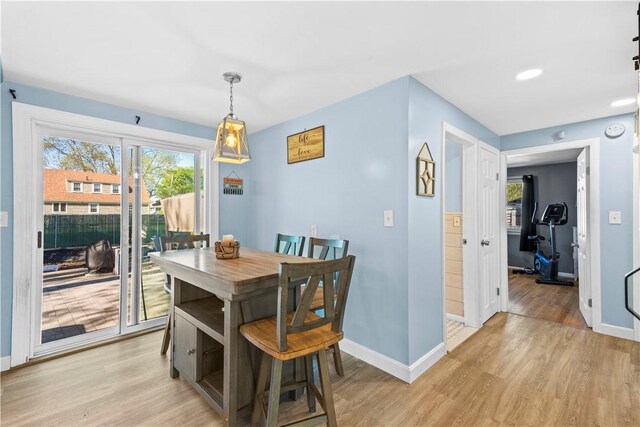 dining space with baseboards, recessed lighting, and light wood-style flooring