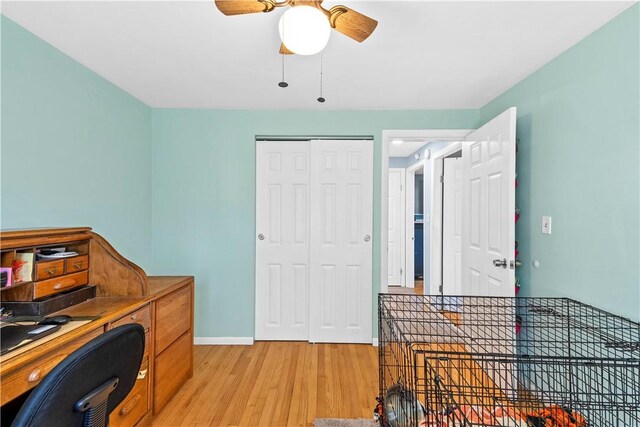 home office with light wood-style floors, baseboards, and ceiling fan