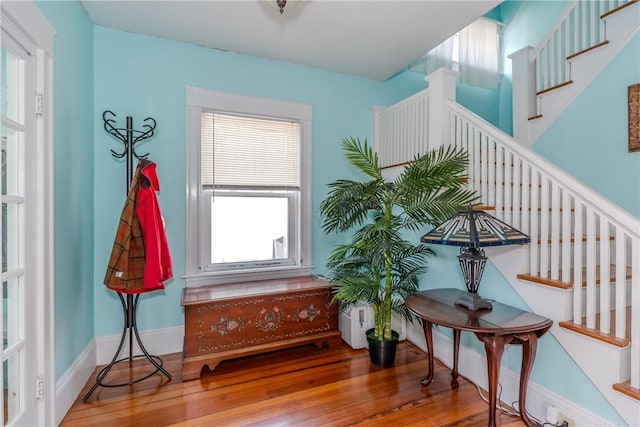 living area featuring stairway and wood finished floors