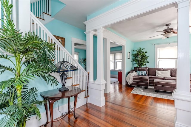 interior space featuring stairs, ornate columns, and ceiling fan