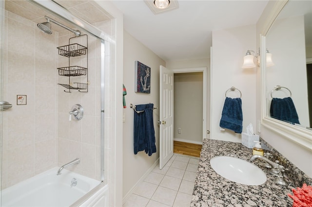 bathroom with shower / bath combination, baseboards, tile patterned flooring, and vanity