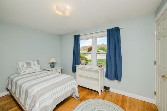 bedroom featuring baseboards and wood finished floors