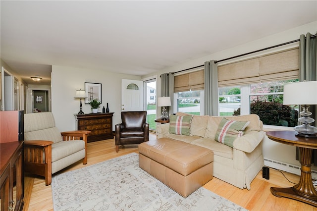 living area with a baseboard radiator and wood finished floors