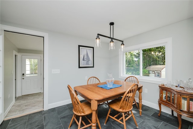 dining room with baseboards and stone finish floor