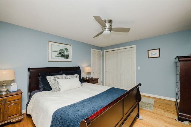 bedroom with a closet, ceiling fan, baseboards, and light wood-type flooring