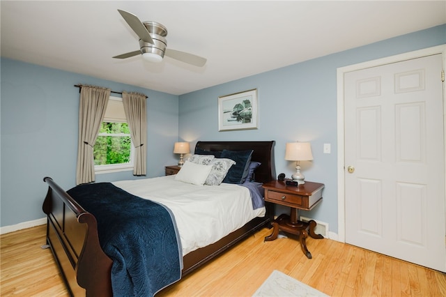 bedroom featuring baseboards, a ceiling fan, and wood finished floors