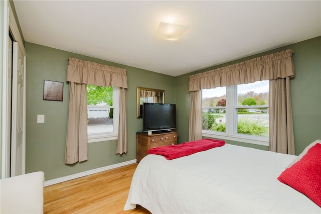 bedroom with baseboards and light wood-style flooring