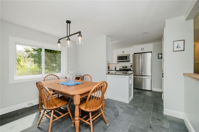 dining area featuring baseboards