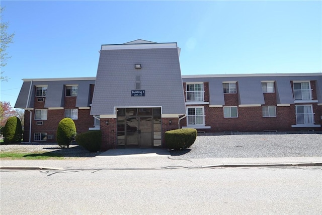300 Smithfield Rd Unit P1-1, Providence, RI 02904 - view of front facade with a garage, driveway, and brick siding