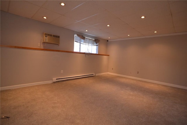 300 Smithfield Rd Unit P1-1, Providence, RI 02904 - below grade area with carpet floors, baseboards, a wall unit AC, a drop ceiling, and a baseboard heating unit
