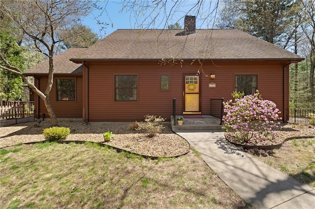 29 Howard Ave, Scituate, RI 02831 - view of front of house featuring fence, a chimney, a shingled roof, and a front lawn