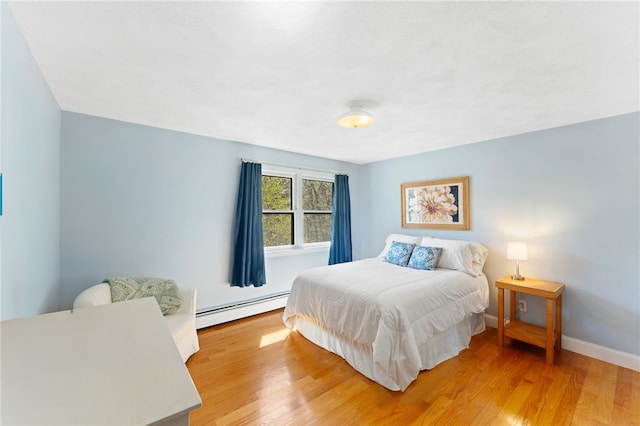 29 Howard Ave, Scituate, RI 02831 - bedroom with baseboards, light wood-style flooring, and baseboard heating
