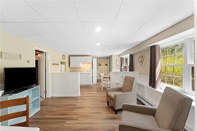 29 Howard Ave, Scituate, RI 02831 - living area featuring a paneled ceiling, a wainscoted wall, a baseboard heating unit, light wood finished floors, and recessed lighting
