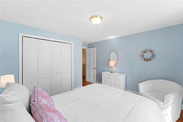 29 Howard Ave, Scituate, RI 02831 - bedroom featuring baseboards, wood finished floors, and a closet