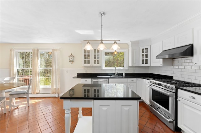 29 Howard Ave, Scituate, RI 02831 - kitchen featuring dark countertops, appliances with stainless steel finishes, dark tile patterned flooring, and under cabinet range hood
