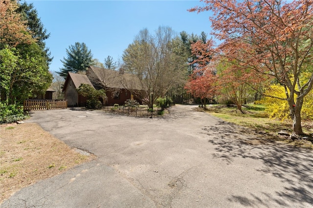 29 Howard Ave, Scituate, RI 02831 - view of front facade with fence and aphalt driveway