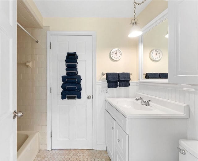 29 Howard Ave, Scituate, RI 02831 - full bath featuring wainscoting, vanity, toilet, tile patterned floors, and bathing tub / shower combination