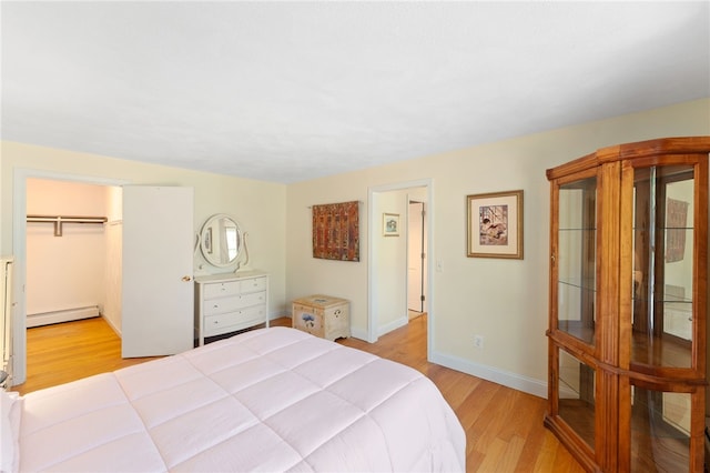 29 Howard Ave, Scituate, RI 02831 - bedroom with light wood-style floors, baseboards, and a baseboard heating unit